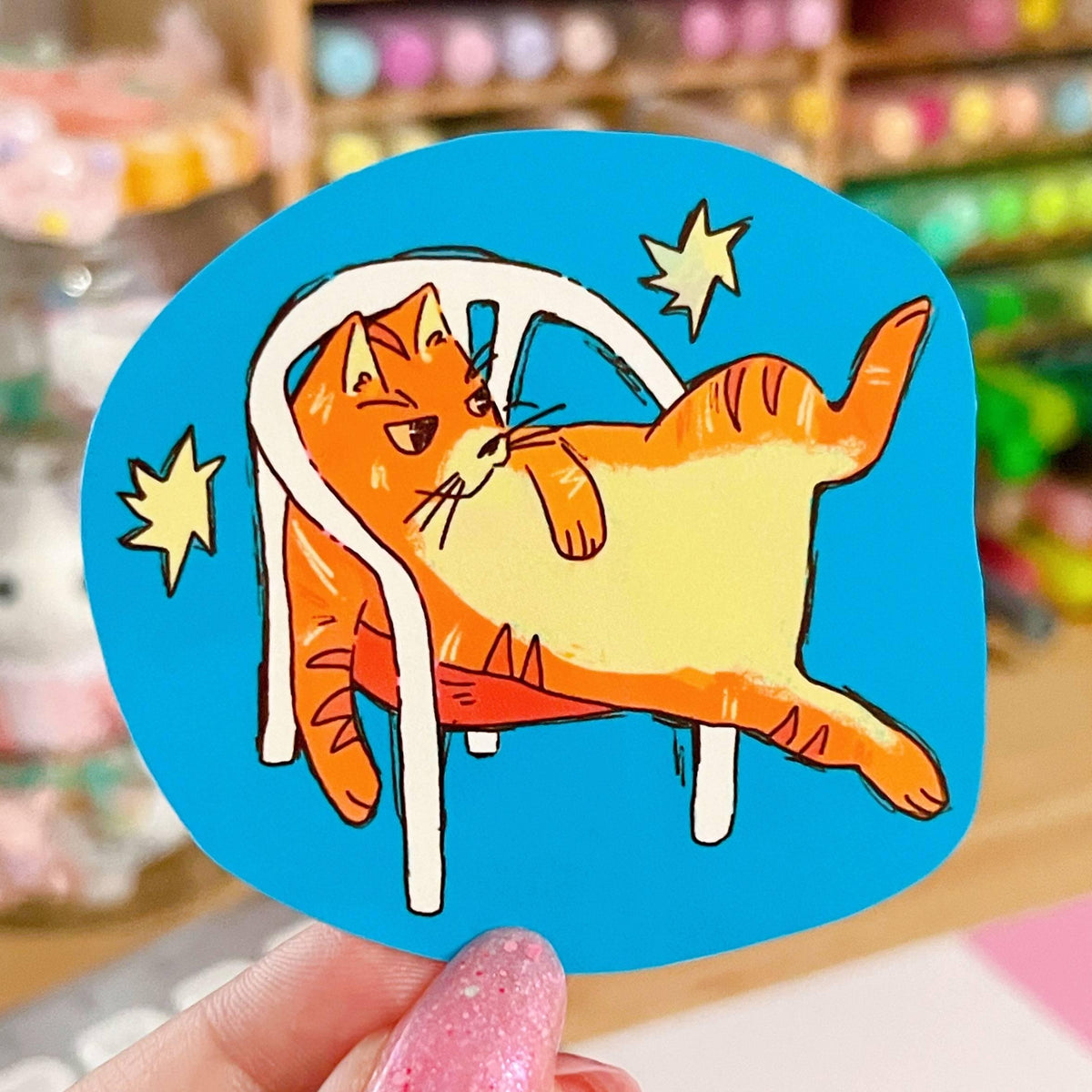 Orange Cat in White Plastic Chair Sticker